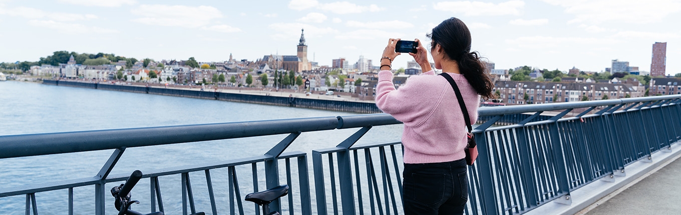 Bicyclist takes photo from bridge