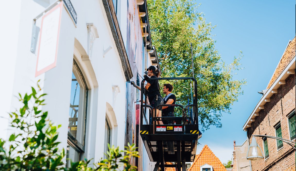 Graffiti artists at work on outdoor platform