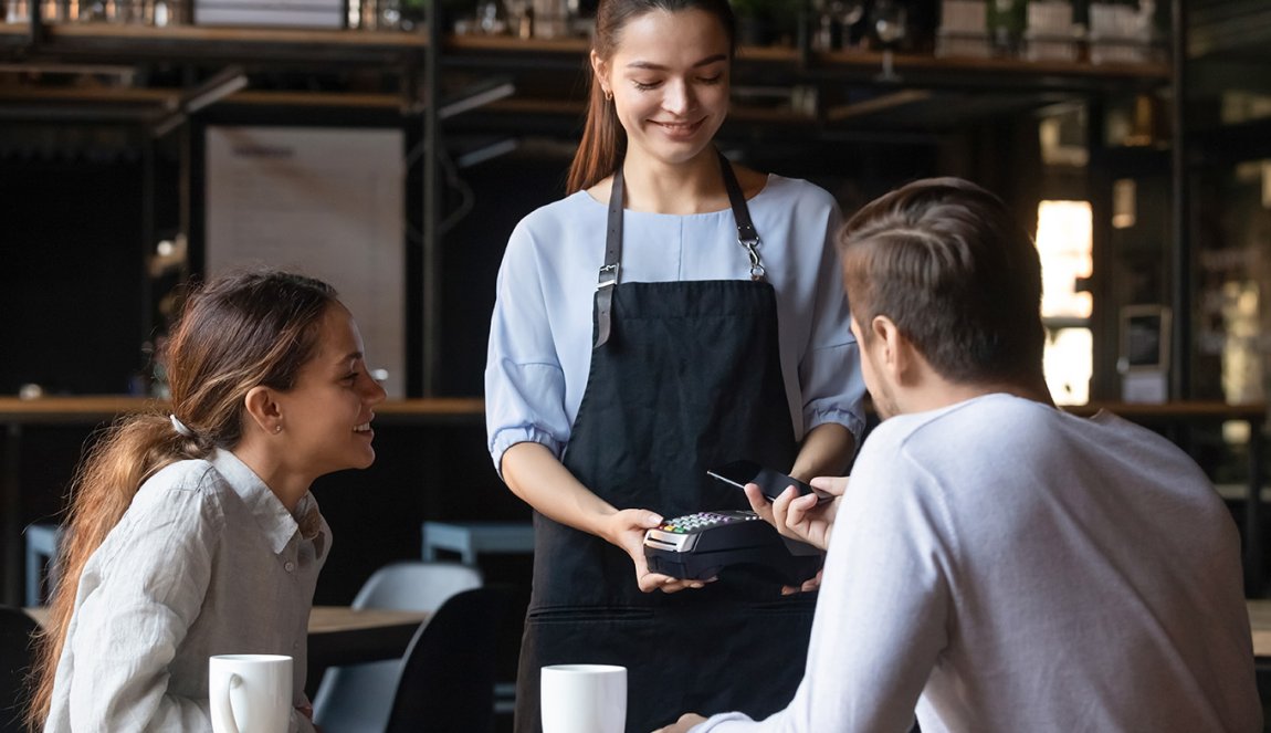 Couple in restaurant paid with mobile phone contactless payment