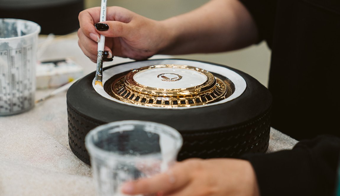 At work in Studio Job with white paint on wheel with gold 