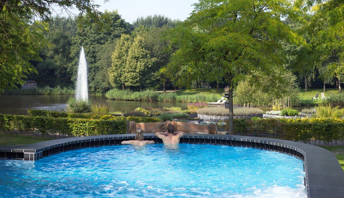 Couple relax in outdoor panaroma pool Thermen Bad Nieuweschans